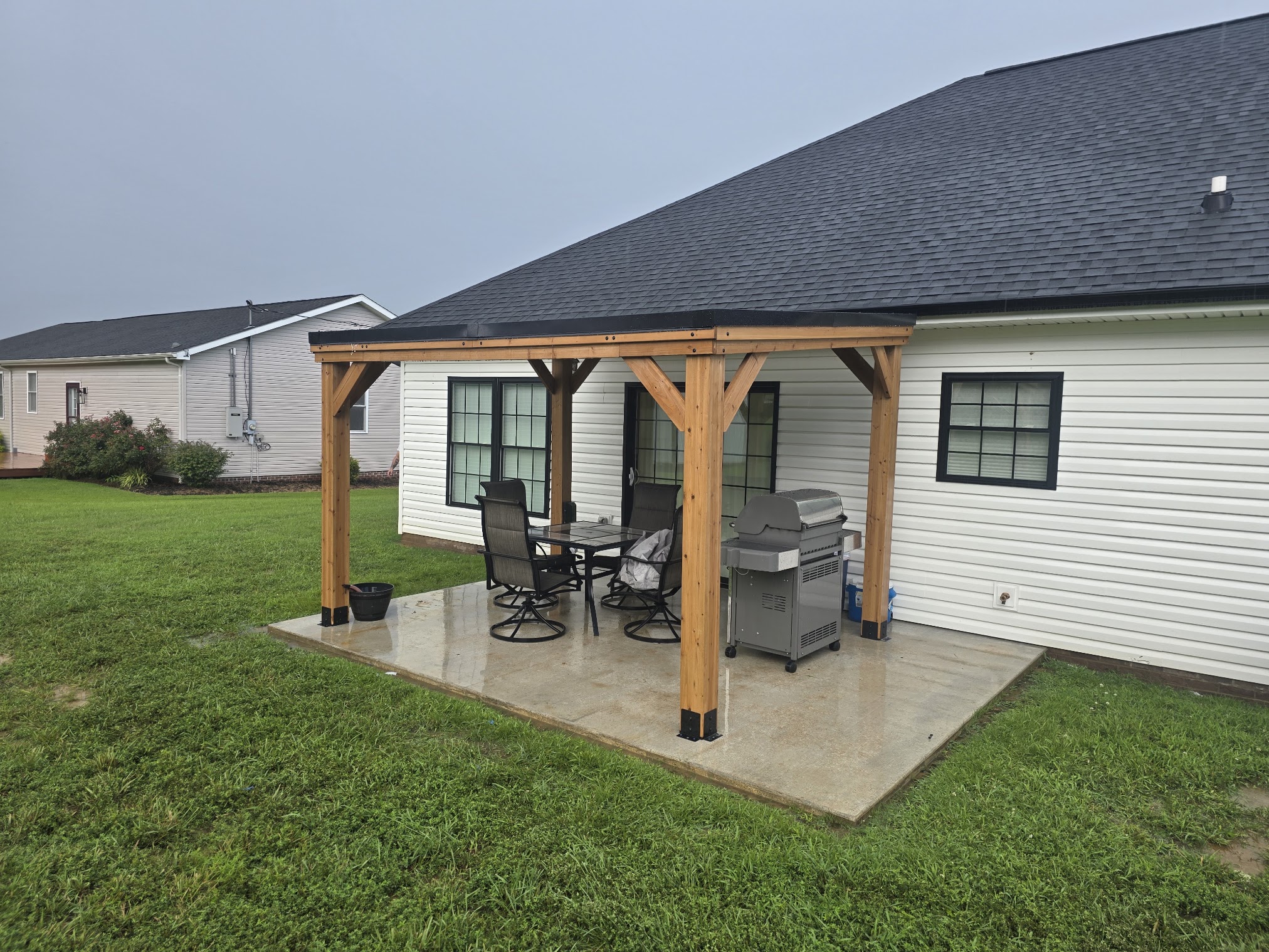 Covered outdoor patio structure with wood posts and metal roof