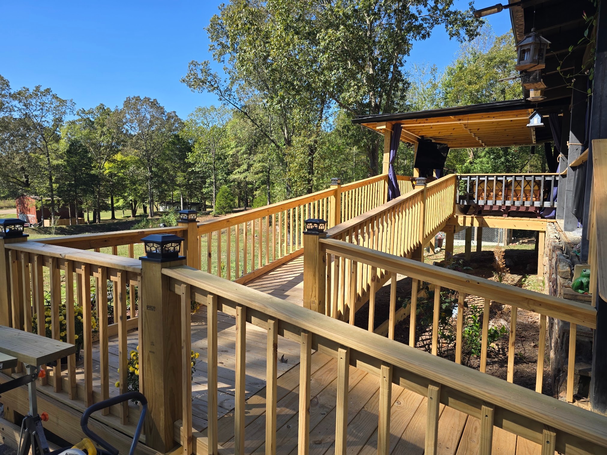 Large multi-level deck and ramp system with wood railing