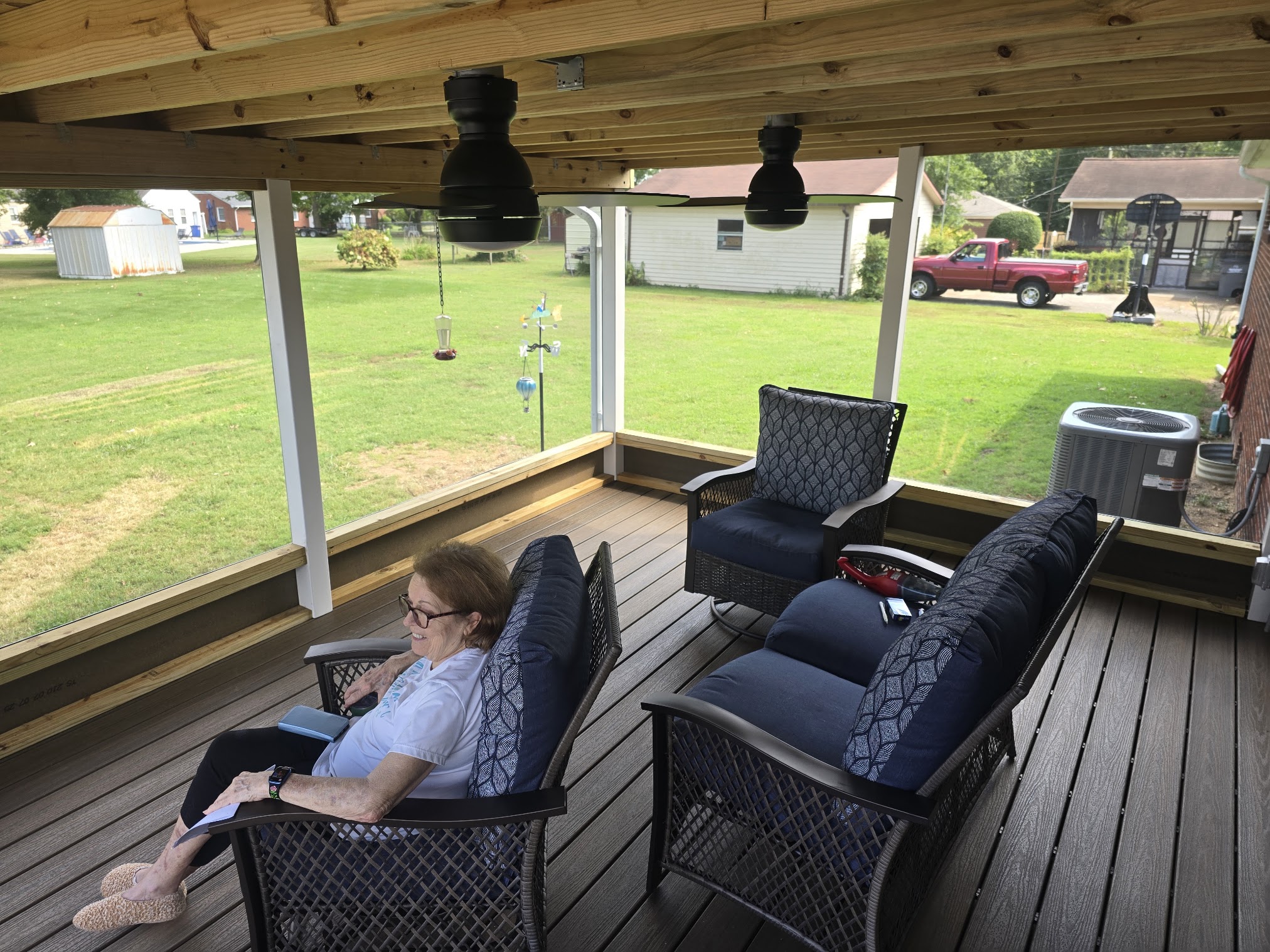 Finished screened-in porch with composite decking and outdoor seating