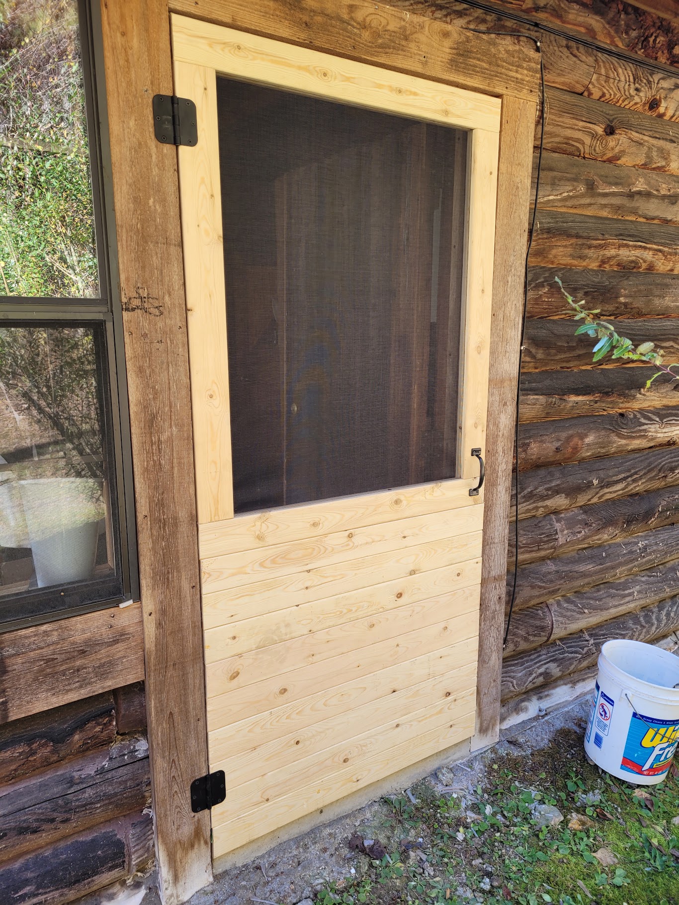 Custom screen door built for a log cabin