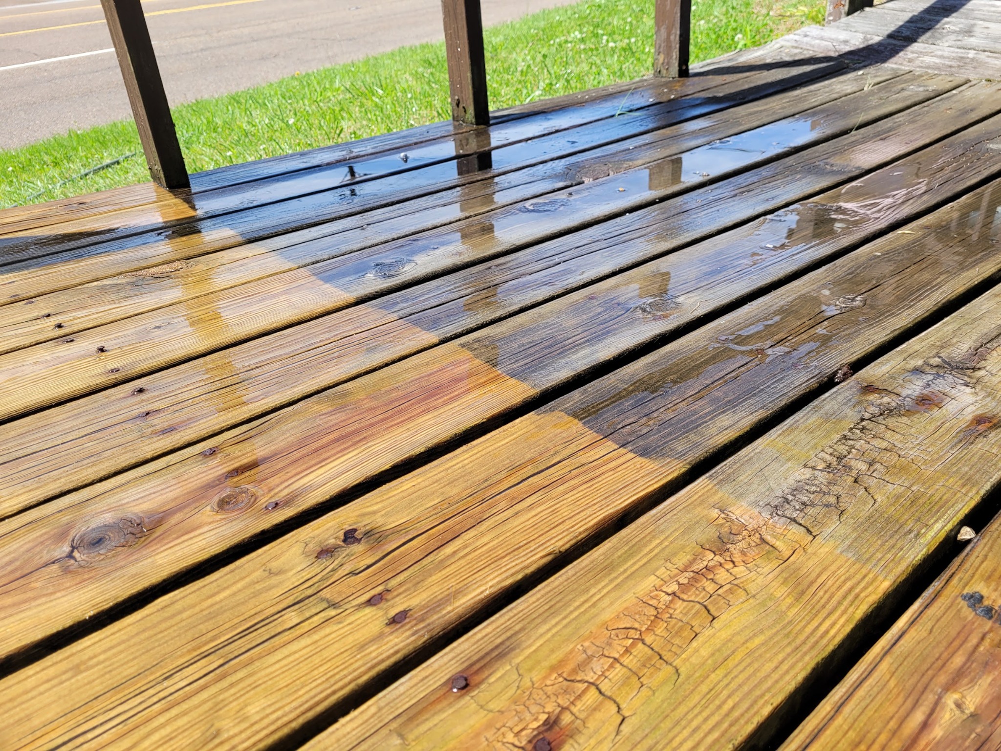 Freshly washed residential wood deck with wet boards